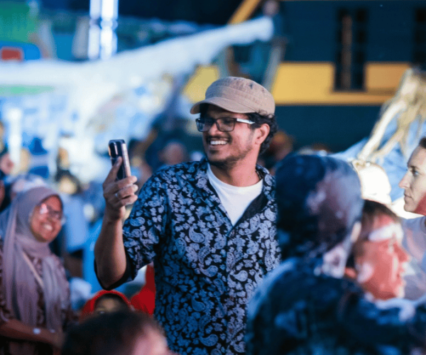 Man smiling and taking photos at Summer Fest