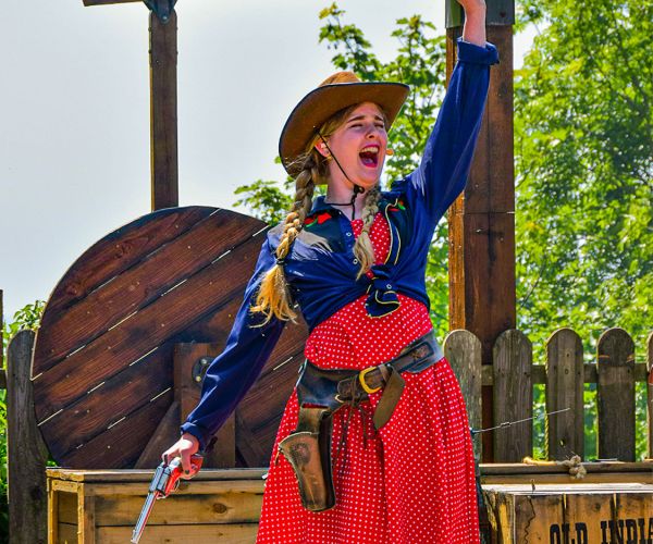 This cowgirl in a red summer dress means business